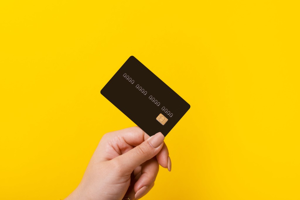 a person holding a credit card which is one debt payment option